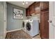Well-organized laundry room with cabinets, a rug, and modern washer and dryer at 13875 Ambria Dr, McCordsville, IN 46055