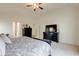 Bright bedroom with a black dresser underneath the TV at 13875 Ambria Dr, McCordsville, IN 46055