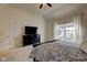 Bright bedroom with a black dresser underneath the TV at 13875 Ambria Dr, McCordsville, IN 46055