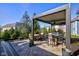 Spacious outdoor patio features a covered dining space, modern patio furniture, and a professionally landscaped yard at 13875 Ambria Dr, McCordsville, IN 46055