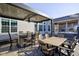 Outdoor living space features a bar area, patio seating, ceiling fan, and view of hot tub at 13875 Ambria Dr, McCordsville, IN 46055