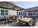 Outdoor living space features a bar area, patio seating, ceiling fan, and view of hot tub at 13875 Ambria Dr, McCordsville, IN 46055