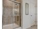 Tiled shower with glass door, complemented by a decorative mirror on the adjacent wall at 13875 Ambria Dr, McCordsville, IN 46055