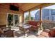 Relaxing screened-in porch with wooden accents, comfortable seating and access to backyard at 13875 Ambria Dr, McCordsville, IN 46055