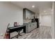 Basement bar area with custom cabinets, stone countertop, wine rack, and recessed lighting at 13875 Ambria Dr, McCordsville, IN 46055