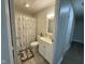 Bathroom featuring a shower with a curtain, a toilet, and a single sink vanity at 1536 W 74Th Pl, Indianapolis, IN 46260