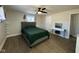 This is a bedroom with wood floors, a ceiling fan, and a white desk with a makeup mirror at 1536 W 74Th Pl, Indianapolis, IN 46260