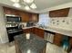 Well-equipped kitchen with stainless steel appliances, granite counters, and a central island at 1536 W 74Th Pl, Indianapolis, IN 46260