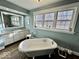 Bright bathroom with a vintage-style tub, white vanity, and charming decor at 155 Boring Pl, Martinsville, IN 46151