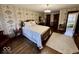 Spacious bedroom showcasing vintage wallpaper, hardwood floors, and a comfortable bed at 155 Boring Pl, Martinsville, IN 46151