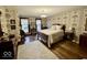 Cozy bedroom featuring floral wallpaper, hardwood floors, and a comfortable bed at 155 Boring Pl, Martinsville, IN 46151