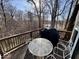 Outdoor deck with furniture and grill, overlooking wooded scenery and a lake at 155 Boring Pl, Martinsville, IN 46151
