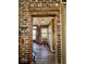 Charming entryway with exposed brick archway, wooden floors, and a view to the front door at 155 Boring Pl, Martinsville, IN 46151