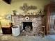 Cozy brick fireplace with mantle, decorative items, and hearth accessories at 155 Boring Pl, Martinsville, IN 46151