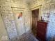 Unique hallway with vintage-style wallpaper, brick floor, and access to additional rooms at 155 Boring Pl, Martinsville, IN 46151