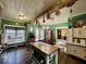 Eat-in kitchen with vintage decor, wooden beams, hardwood floors, and a view to other rooms at 155 Boring Pl, Martinsville, IN 46151