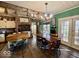 Unique eat-in kitchen features exposed brick, decorative touches, hardwood floors, and a vintage-style design at 155 Boring Pl, Martinsville, IN 46151