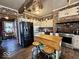 Well-lit kitchen features brick walls, stainless steel appliances, and eat-in island at 155 Boring Pl, Martinsville, IN 46151