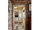Charming kitchen with shelving visible through brick framed doorway at 155 Boring Pl, Martinsville, IN 46151