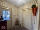 Mudroom with brick floor and vintage wallpaper at 155 Boring Pl, Martinsville, IN 46151