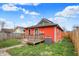 Cozy backyard featuring a wooden deck, vibrant lawn, and orange vinyl siding at 1715 E Kelly St, Indianapolis, IN 46203