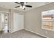 Bedroom with carpet, ceiling fan, window, and a closet with white doors at 1715 E Kelly St, Indianapolis, IN 46203