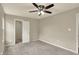 Neutral bedroom featuring a ceiling fan, carpet, a window with blinds, and a closet at 1715 E Kelly St, Indianapolis, IN 46203
