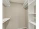 Walk in closet with built-in shelving and hanging rails for ample storage at 1715 E Kelly St, Indianapolis, IN 46203