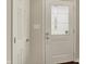 Bright entryway featuring a modern door with decorative glass and a nearby coat closet at 1715 E Kelly St, Indianapolis, IN 46203