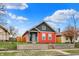This home boasts great curb appeal, featuring a colorful two-tone exterior and a well-kept front yard at 1715 E Kelly St, Indianapolis, IN 46203