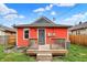 Back exterior featuring a wooden deck, an entry door, and green space at 1715 E Kelly St, Indianapolis, IN 46203