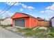 Exterior view of a detached garage featuring an orange vinyl facade and gray door at 1715 E Kelly St, Indianapolis, IN 46203