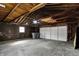 Spacious garage with unfinished walls and a modern white garage door at 1715 E Kelly St, Indianapolis, IN 46203
