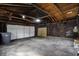 Spacious garage with unfinished walls and a modern white garage door at 1715 E Kelly St, Indianapolis, IN 46203