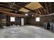 Unfinished garage with exposed wood framing and lighting fixtures at 1715 E Kelly St, Indianapolis, IN 46203