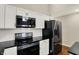 Modern kitchen showcases stainless steel appliances and sleek black countertops at 1715 E Kelly St, Indianapolis, IN 46203