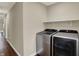 Functional laundry room with stainless steel washer, dryer, and storage shelf at 1715 E Kelly St, Indianapolis, IN 46203