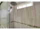 Close up on shower boasting textured gray tiling, mosaic accent, and rainfall shower head at 1715 E Kelly St, Indianapolis, IN 46203