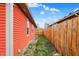 Landscaped side yard showcasing the vinyl siding and well-maintained fence at 1715 E Kelly St, Indianapolis, IN 46203