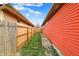 A narrow side yard featuring a well-maintained fence and lush green grass at 1715 E Kelly St, Indianapolis, IN 46203