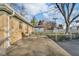 Backyard features a patio and a view of the detached garage with chain link fence at 1731 N Campbell Ave, Indianapolis, IN 46218