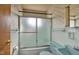 Bathroom showcases a glass shower door and retro blue and white color scheme at 1731 N Campbell Ave, Indianapolis, IN 46218