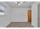 Bedroom has neutral carpet, two windows and a closet with a wooden door at 1731 N Campbell Ave, Indianapolis, IN 46218