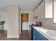 An inviting view of the kitchen with laundry area access, featuring laminate flooring at 1731 N Campbell Ave, Indianapolis, IN 46218