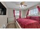 This bedroom features a decorative ceiling fan, red curtains and a large bed at 1731 N Campbell Ave, Indianapolis, IN 46218