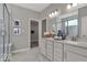 Bright bathroom boasts double vanity, framed mirrors, and walk-in closet access for ample storage at 20147 Chad Hittle Blvd, Westfield, IN 46074