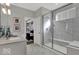 Bathroom featuring a glass shower with white marble surround, seating, and neutral colors at 20147 Chad Hittle Blvd, Westfield, IN 46074