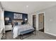 Beautiful bedroom with a blue accent wall, bench, and doorways leading to closet and bathroom at 20147 Chad Hittle Blvd, Westfield, IN 46074