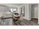 Bright dining area featuring a wooden table, six chairs, and two large mirrors reflecting natural light at 20147 Chad Hittle Blvd, Westfield, IN 46074