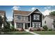 Charming two-story home featuring a mix of gray and black siding, brick accents, and a welcoming front porch at 20147 Chad Hittle Blvd, Westfield, IN 46074